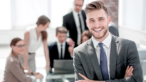 man smiling and crossing arms